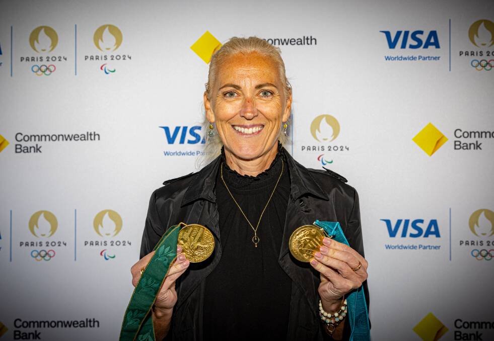 Kerri Pottharst poses with her Olympic gold and bronze medals. Picture by Eddie Guerrero