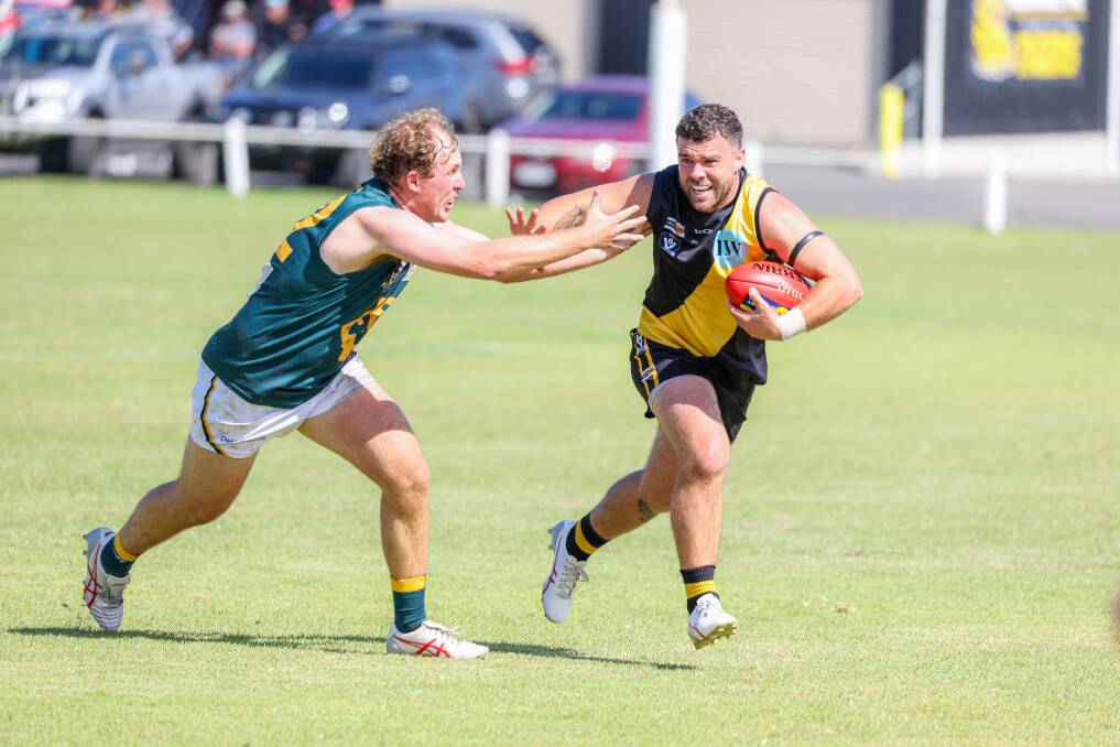 Merrivale's Trent Harman shakes off the tackle in his debut for the club. 