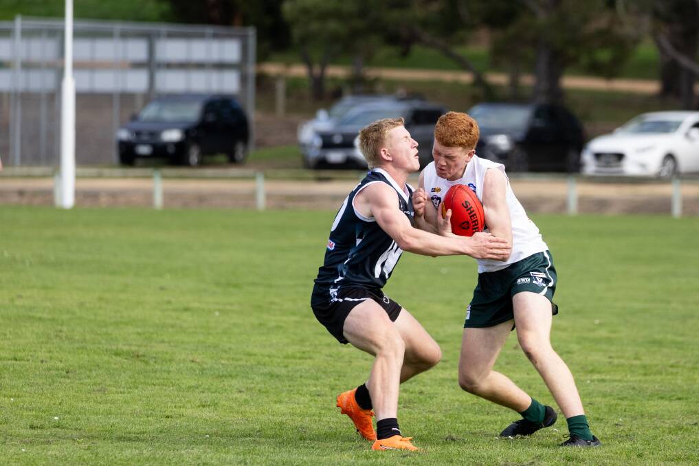 Hampden West's Eddie McShane looks to take the tackle on against Wimmera in the under 17s.
