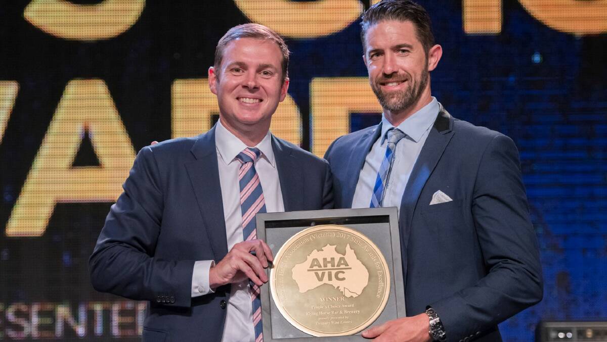 Flying Horse managing director Matthew Monk, right, receives the Australian Hotels Association's People's Choice award from Angus McPherson of Treasury Wine Estates.
 