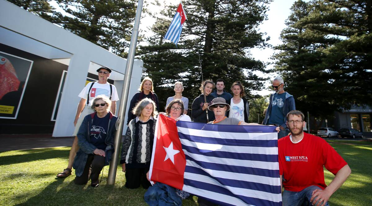 Campaigners: Members of the Warrnambool group seeking an independent West Papua raise the West Papuan flag at the Civic Green. Picture: Amy Paton