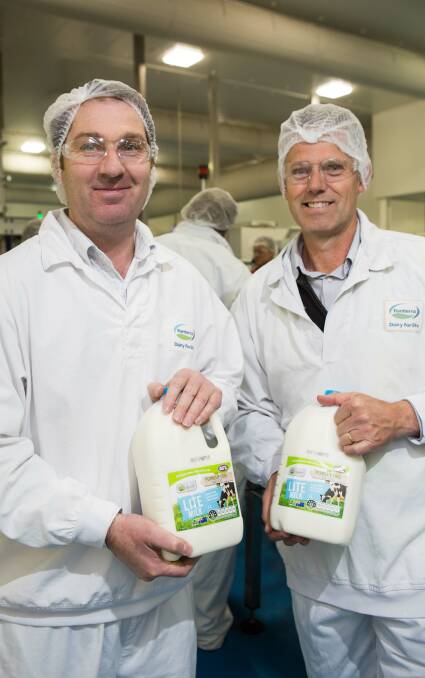 Producing: Brett Rowlands and Andrew Nooy with some of the first commercial milk to be produced at Fonterra's new Cobden plant.