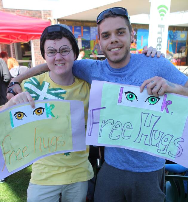 Simple gesture: Leith Hunt and Kalijah Madison were dispensing free hugs at the Get Amongst It day for mental health.