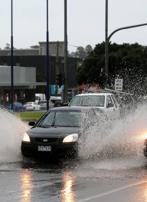A car sprays up water on Raglan Parade during Monday's storms. 
