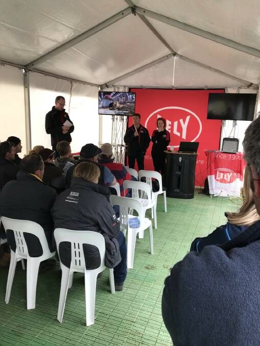 Field day: Phil, front centre, and Symone Vines speak at the field day that was also addressed by Jurgen Steen, front left, from Lely Australia.  