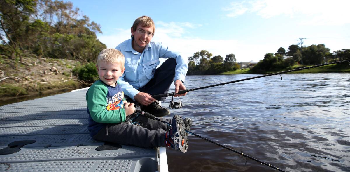 Dropping a line: Justin Harzmeyer and son Blake, 3, at one of the new fishing jetties on the Merri River. Picture: Amy Paton