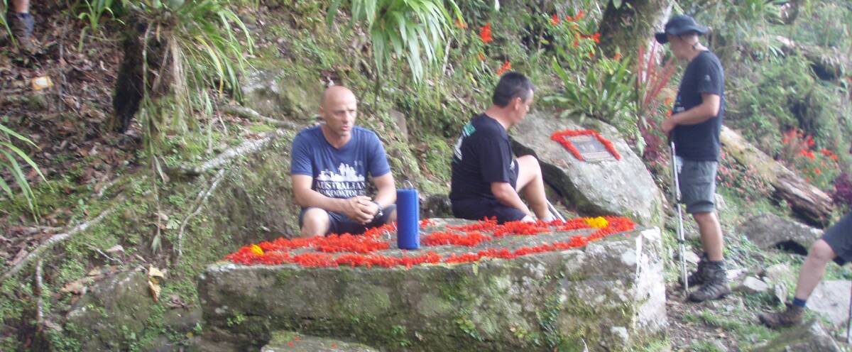 Solemn: Let's Talk walkers at the Surgeon's Table on the Kokoda Trail.