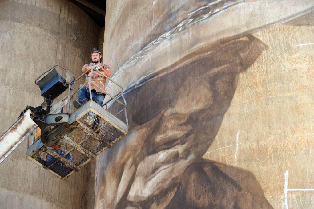 Guido van Helten with his mural at Brim Silo. Picture: PAUL CARRACHER
