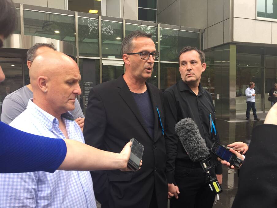 SHOCKED: Clergy sex abuse survivors Andrew Collins and David Ridsdale outside the County Court with supporter Daniel Mellmann after news broke Cardinal George Pell would no longer front the inquiry. Picture: Melissa Cunningham 