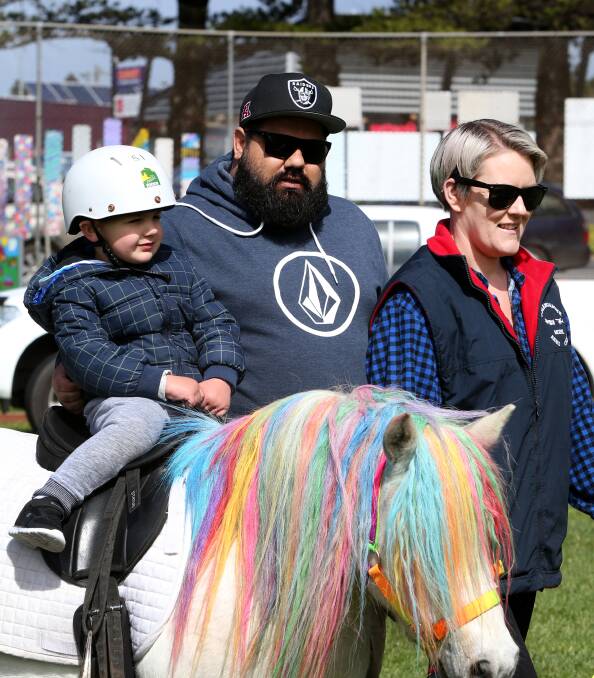 GOING FOR A RIDE ON A MAJESTIC STEAD: Preston Miller, 3, rides the very colourful Sparkles the pony, lead by Hayley Baulch from Rundles Mahogany Trails. 