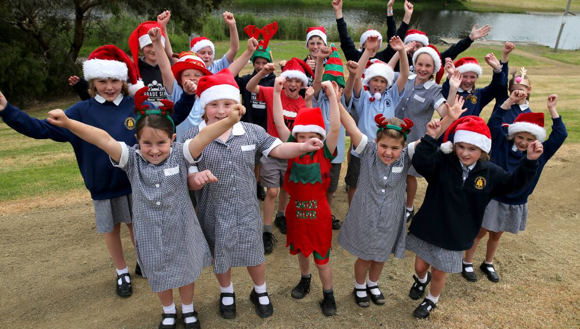 HOORAY: Students from St John's Primary School in Dennington are ready for Friday's Carols by the Merri. Picture: Rob Gunstone
