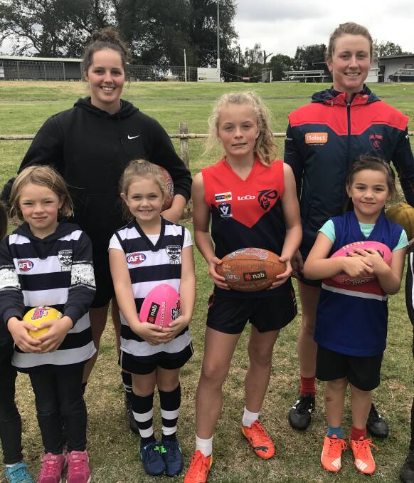 AFLW Melbourne Demons player Shelley Scott with some young fans. 