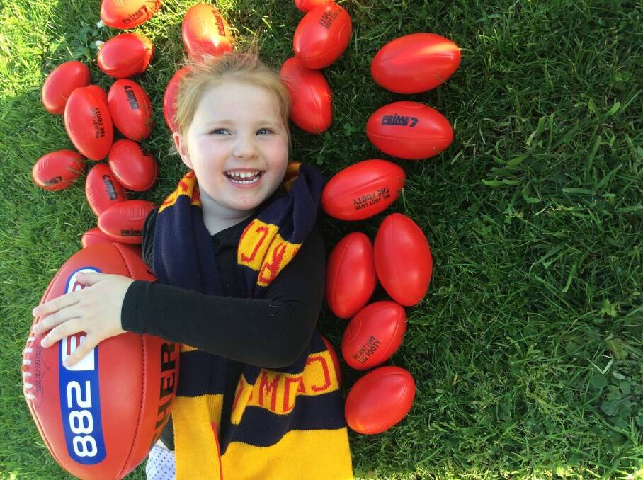 GET READY: Adele Pinkerton, 4, is excited for footy fever on Warrnambool's Civic Green on Friday, ahead of the AFL grand final. 
