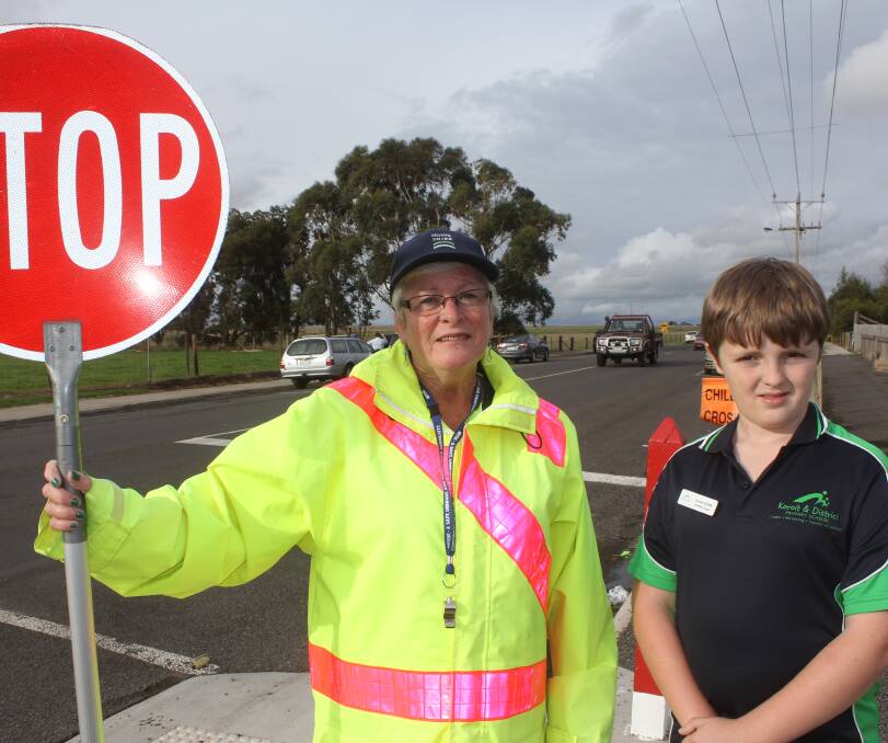 Upgrade likely: Crossing supervisor Sue Hand and Koroit and District Primary School pupil Samuel Sutcliffe at the school crossing in 2014. Picture: Anthony Brady 