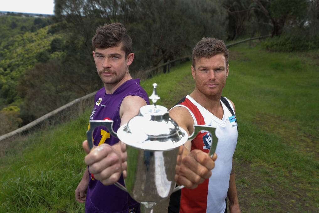 LEAD THE WAY: Port Fairy's Dan Nicholson and Koroit's Isaac Templeton hold up the Hampden league premiership cup ahead of the grand final. Picture: Rob Gunstone