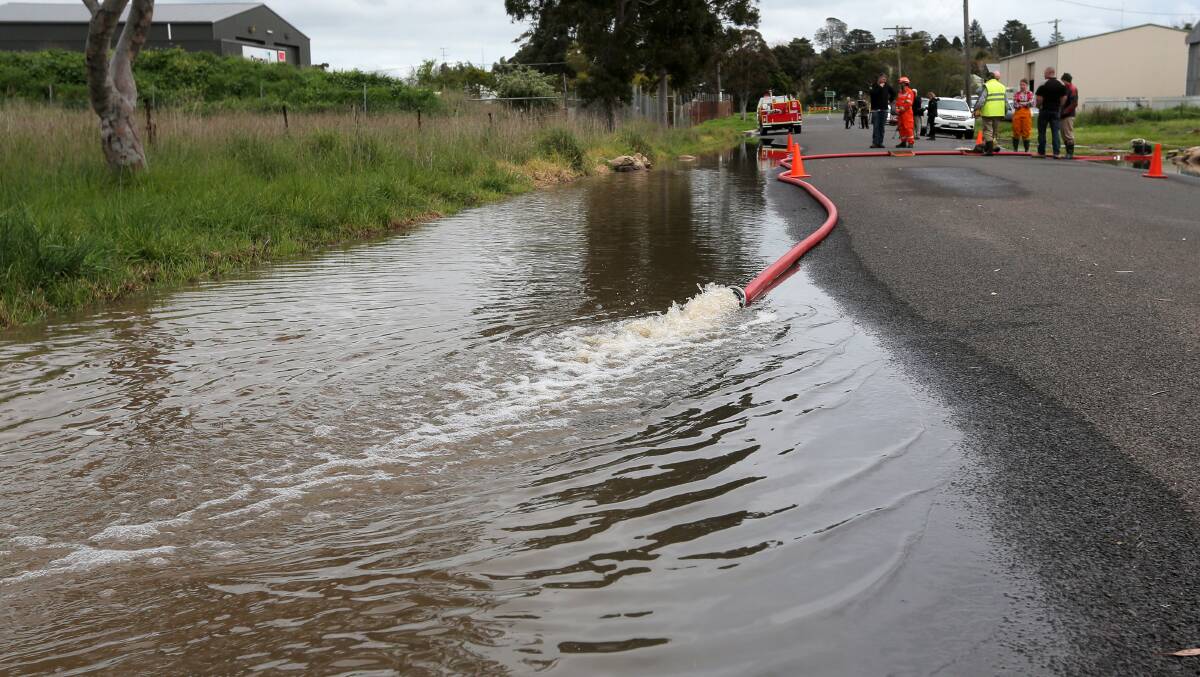 CLEAN UP: Flood water is pumped away from Abbott Street in Hamilton earlier this month. Picture: Rob Gunstone