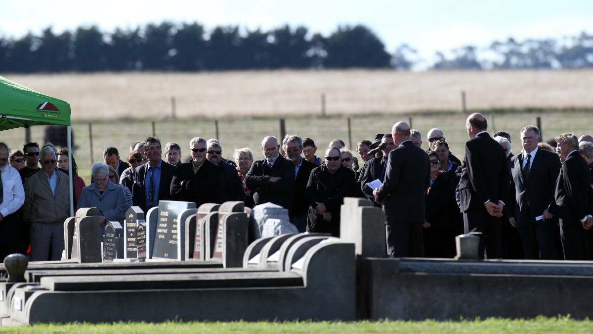 Mourners gather at Mr Sanders' funeral.
