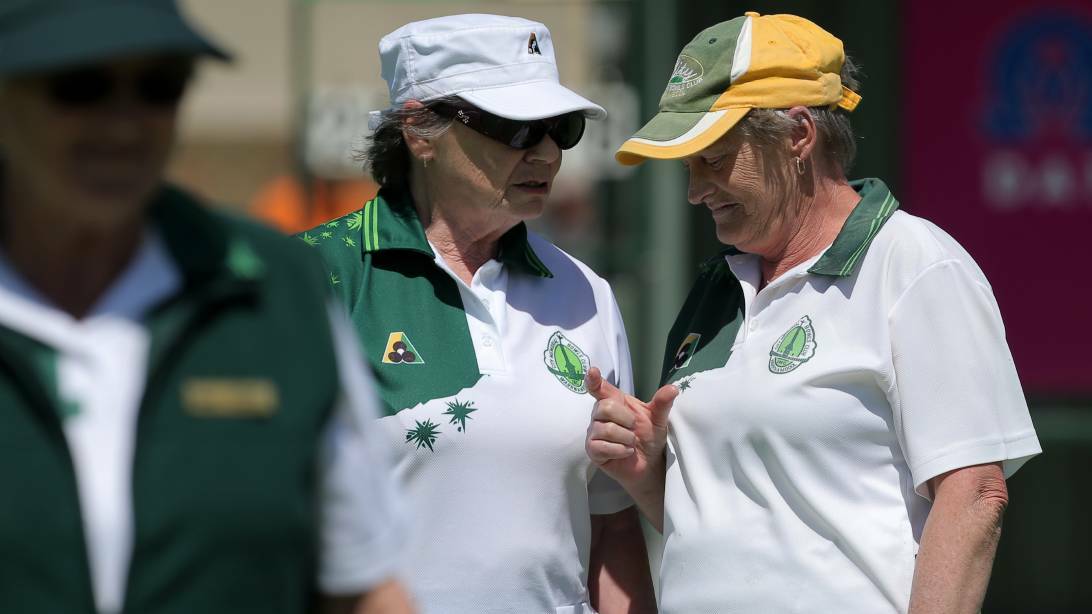 THIS CLOSE: City Memorial bowlers Margaret Hoy and Kaye Maddern discuss tactics in their three-shot win over Warrnambool Gold on Tuesday. Picture: Rob Gunstone