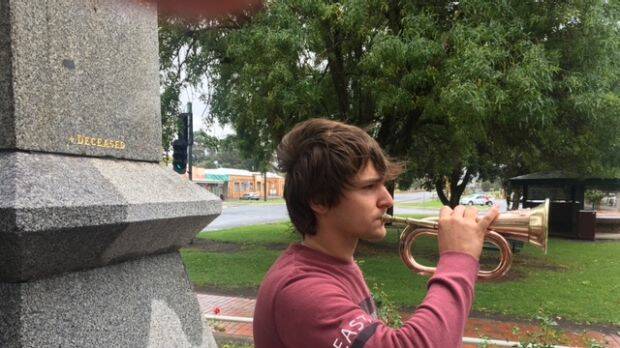 Bullrider Joseph Patterson, 19, at the Heywood War Memorial obelisk. Patterson travels back to Heywood for Anzac Day each April to play the old bugle. Photo: Supplied
