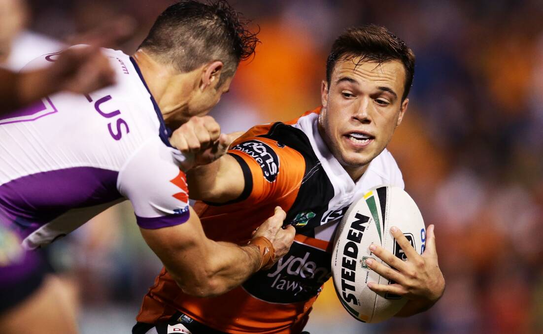 OUT TO WIN: Luke Brooks of the Tigers takes on the defence during the round seven NRL match between the Wests Tigers and the Melbourne Storm.