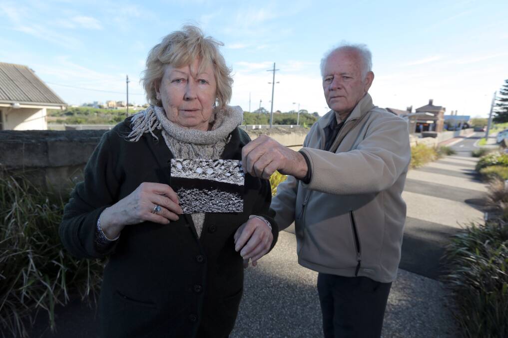 Colac's Margaret Baker and friend Roger Ivens with an image of the gaps in the Merri Street footpath in Warrnambool. Ms Baker suffered broken bones in her left hand/wrist during a fall. Picture: Rob Gunstone

