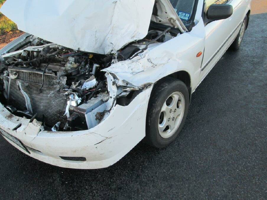 A white Mazda sedan received significant front-end damage in a collision with a school bus near Koroit.