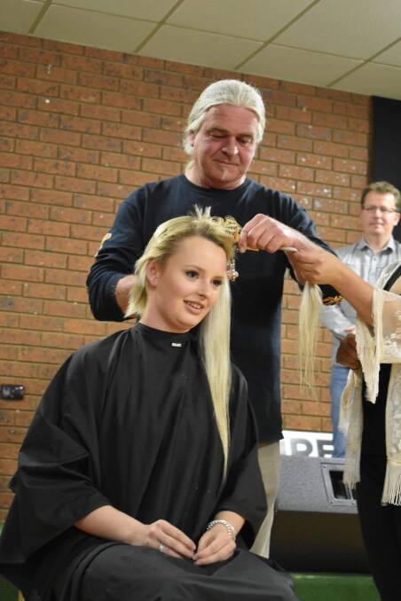 CHOPPED OFF: Georgia Billings' uncle Pat Malone helps cut her hair on Saturday night.