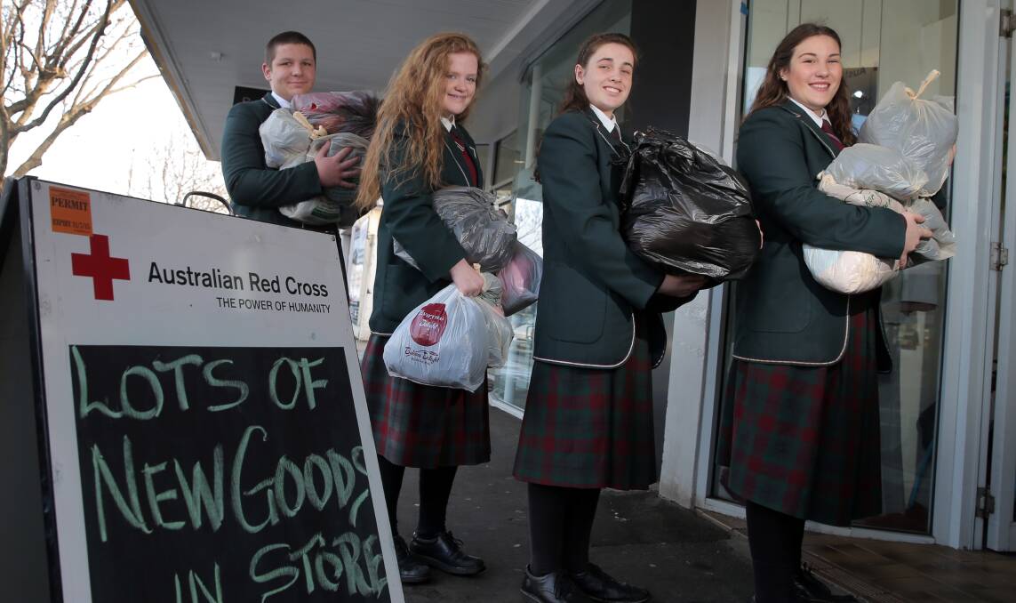 WINTER APPEAL: Brauer College's Noah Steel, 17, Ashleah Kay, 16, Ruby McFadden, 17, and Charlotte Cossens, 17, deliver clothes to the Warrnambool Red Cross shop after a collection at the school. Picture: Rob Gunstone