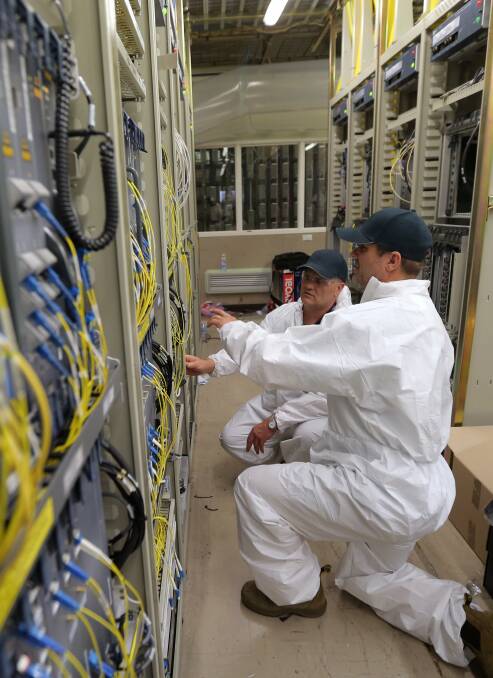 Telstra technicians check new wiring at the Warrnambool exchange.
