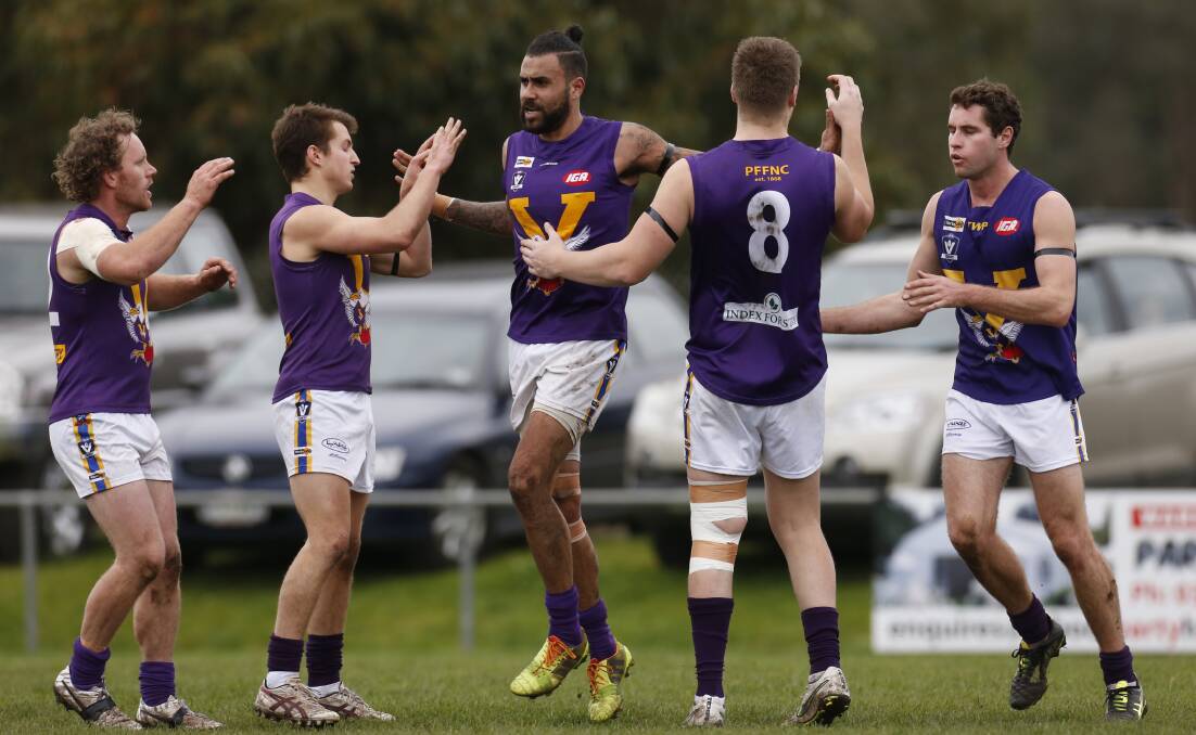 Port Fairy players celebrate Jonathan Proud's goal after the siren at the end of the first quarter on Saturday. Picture: Aaron Sawall