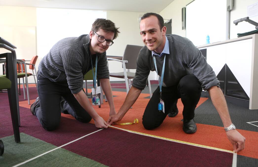 GRADS: Teach For Australia associates Anthony Kingma and Chris Cato go through some practical maths problems during their education training. Picture: Amy Paton