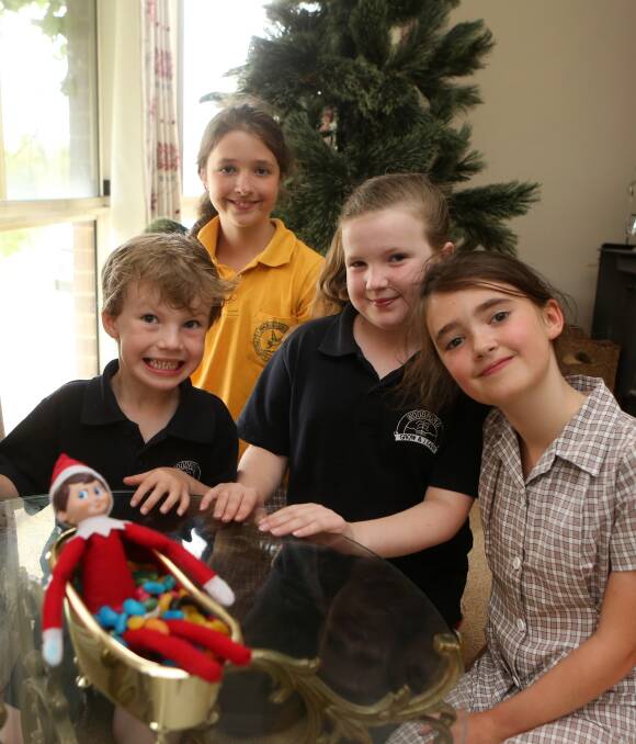 Exciting Elf: The Elf on the Shelf that lives at Tanya Waterfall's house in Woodford has been keeping everyone guessing. Pictured are Nate, 6, Isabella, 10, Chelsea, 9, and Scarlett, 8. Picture: Amy Paton
