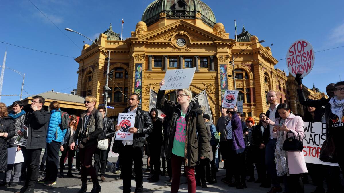 VOCAL: Protesters stop traffic outside Flinders Street station, protesting against planned border protection raids.