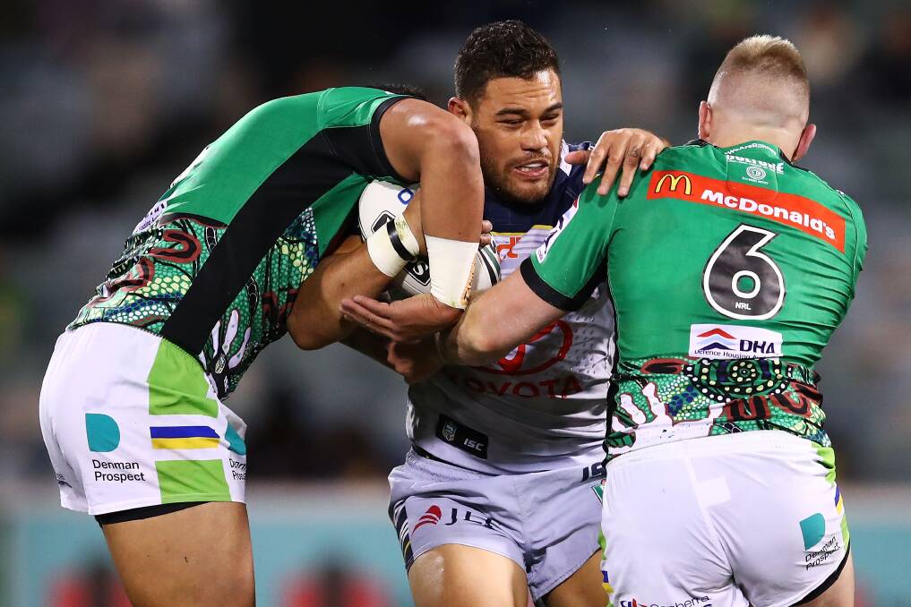 Antonio Winterstein of the Cowboys is tackled by Blake Austin of the Raiders during match between the Canberra Raiders and the North Queensland Cowboys. (Photo by Brendon Thorne/Getty Images)