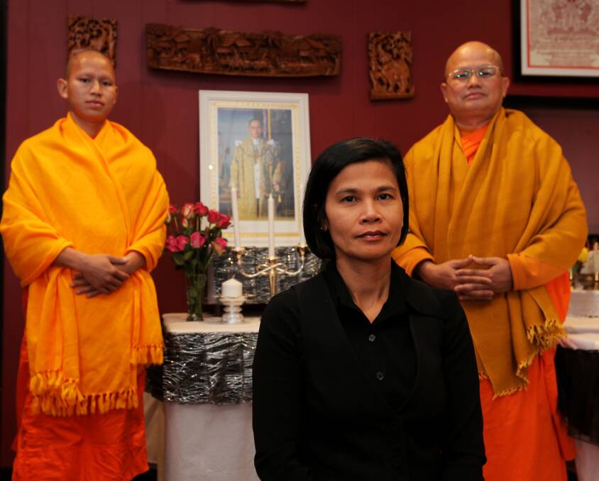 Service: Ronnie Knackstedt, owner of Authentic Siamese Thai restaurant, with Buddhist monks Venerable Surachai (left) and Venerable Boonsom, as they mourn the death of the King of Thailand. Picture: Rob Gunstone