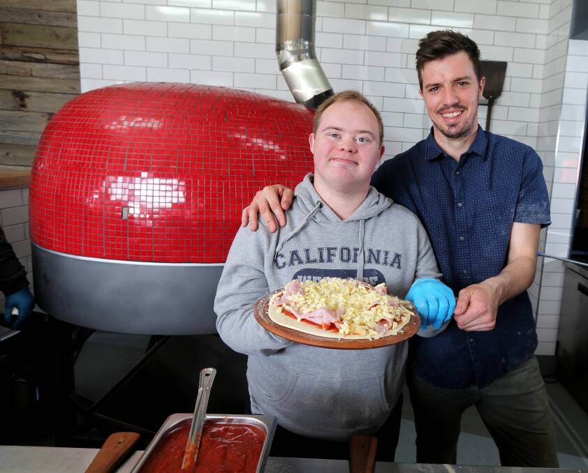Taste sensations: Justin Dwyer was one of five Karingal participants to get some expert pizza-making advice from Mr Brightside owner Jarrod McSween in Warrnambool on Tuesday. Picture: Rob Gunstone