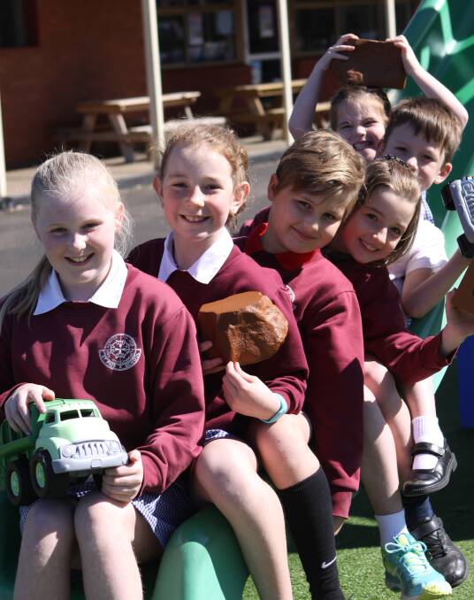 Tour to triumph: The efforts of Lilly Sanderson,10, Matilda Sewell,10, Harry Sanderson,8, Indigo Sewell,8, Jai Keane,6, Blair Forth,5, have paid off with new outside-play equipment at St Pius X. 