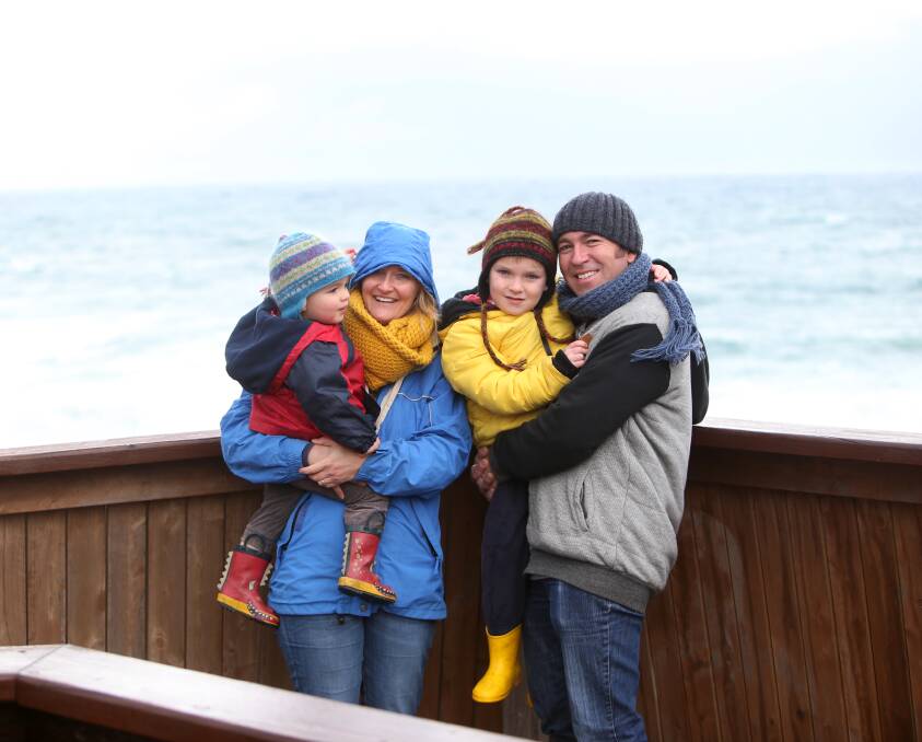 HAVING AN ICE TIME: Geelong's Melanie and Andrew Humphrey, with children Freddie, 2, and Lenny, 4, piled on the extra layers while looking out for whales on Friday. Picture: Amy Paton