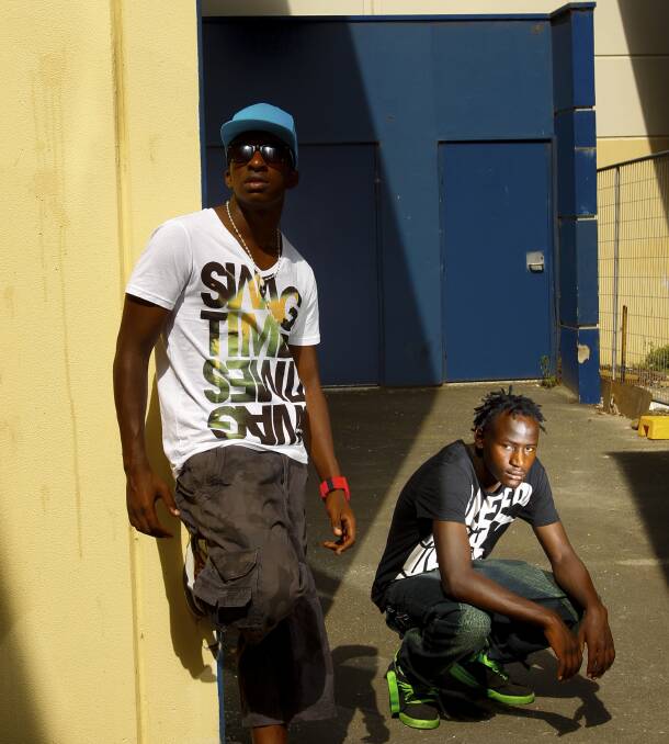 DOGS OF WAR: Fablice Manirakiza (left), pictured with his nephew G-Storm, a fellow rapper, refugee and former child soldier. Picture: Michael Copp