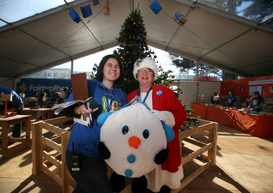 CHRISTMAS IN JUNE: TAFE tourism student Emily McCullagh and Santa's Workshop manager Chris Tingle AKA Mrs Claus in the Christmas-themed woodwork area. 