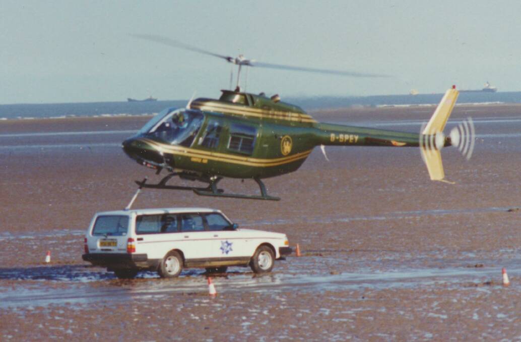 Jerry Grayson paints the roof of a moving car with a helicopter for a British TV show. 