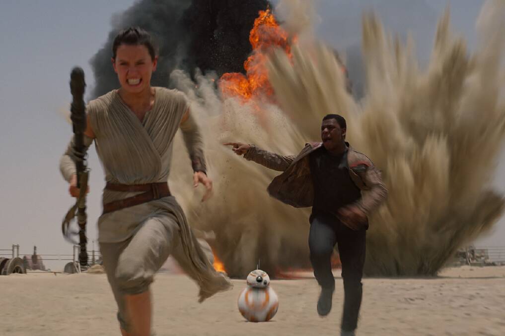 Rey (Daisy Ridley), BB8, and Finn (John Boyega) are on the run from The First Order in Star Wars - The Force Awakens.