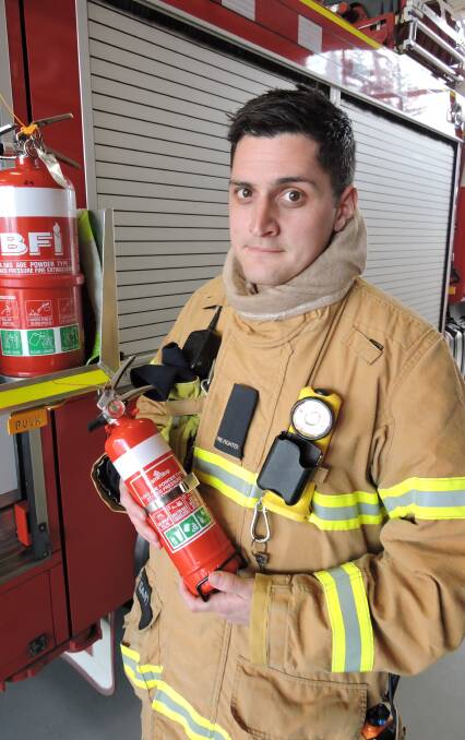 FIRE READY: Warrnambool brigade firefighter Braydn Di Sante with the type of fire extinguisher that helped avert two serious blazes in Warrnambool this week.