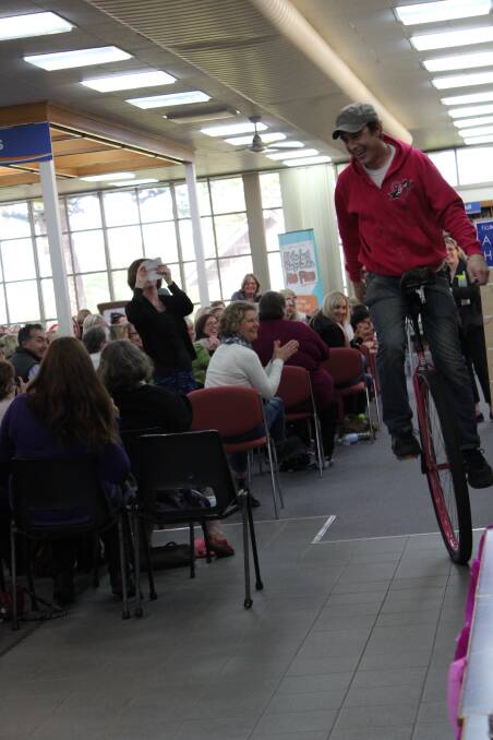 Samuel Johnson shows off his unicycling skills at the Portland Library while raising money for breast cancer charity Love Your Sister.