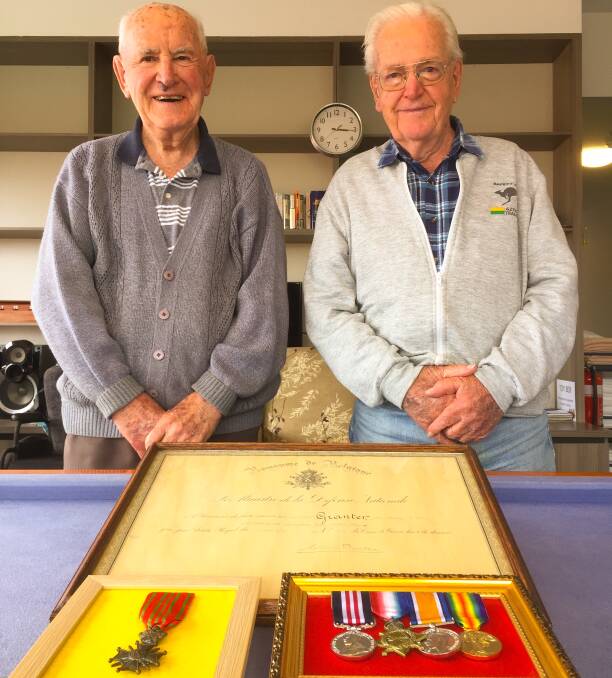 Reunited: Brothers Murray (left) and Jack Granter with their father's medals, including his Belgian Croix de Guerre, and diploma from the Belgian government. 