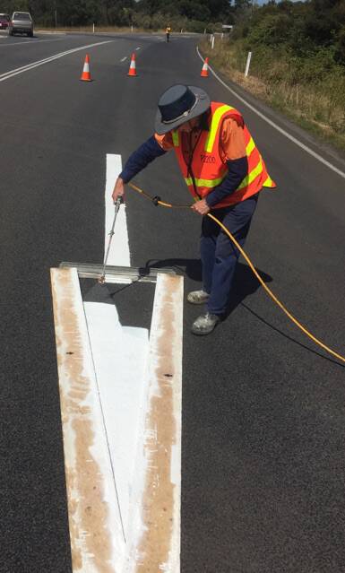 Directional arrows being painted along tourist routes.