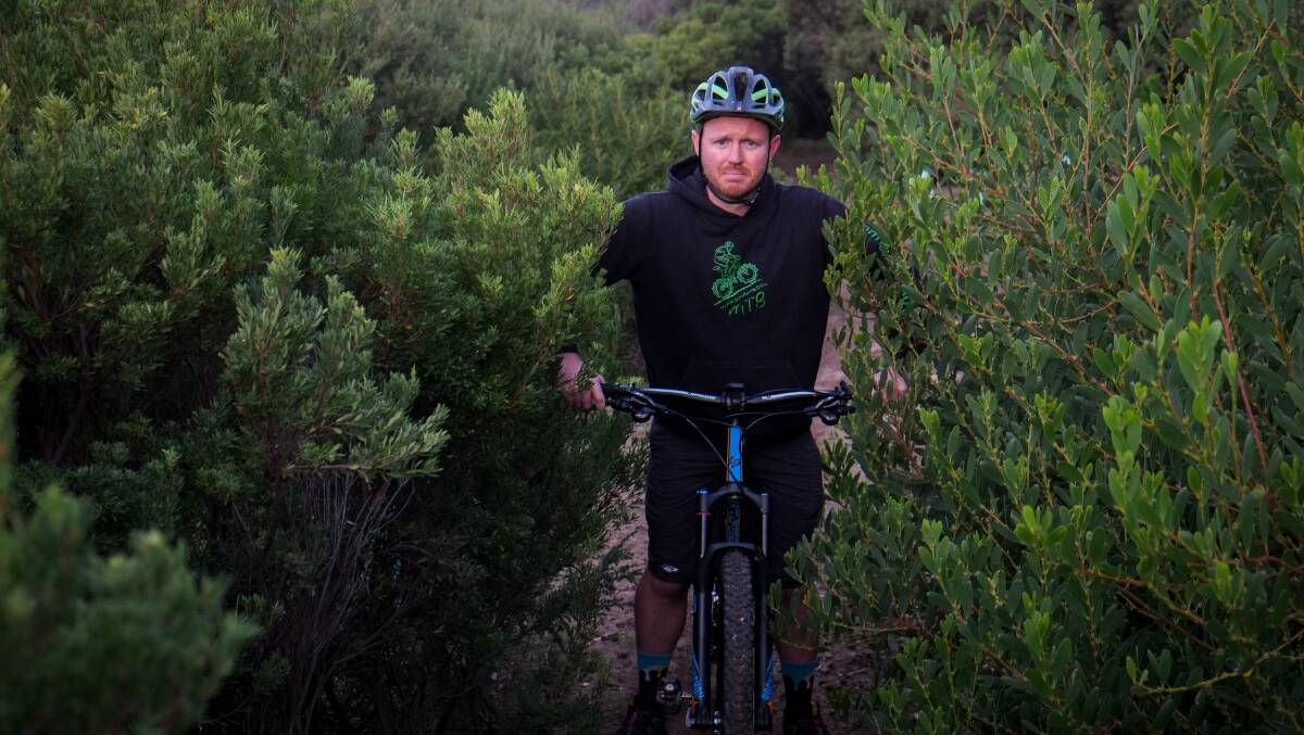 Not happy: Warrnambool Mountain Bike Club president Brett Easton on the overgrown trail. Picture: Rob Gunstone