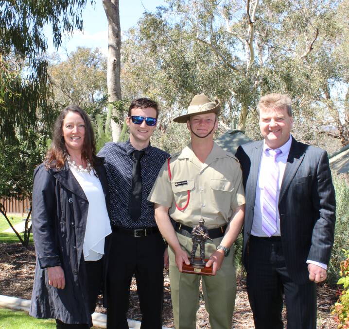 Dream come true: Hamish McConachy shares his award win for most outstanding soldier at the march out parade with mum Karen, brother Angus and dad Andrew.
