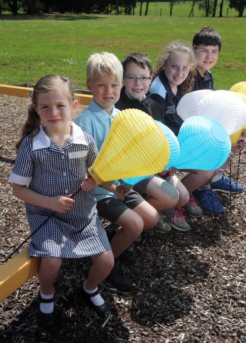Shining a light: Nullawarre pupils Lottie Wallace, 5, Hayden Nevill, 6, Riley Doherty, 8, Sophie Walsh, 12, and Nicholas Kilvington, 12, with the lanterns. Picture: Rob Gunstone