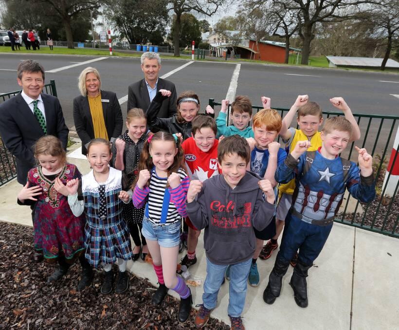 Celebration: Terang College junior campus pupils celebrate the funding to install new flashing 40km/h signs at their school crossing, with Roads Minister Luke Donnellan, Corangamite Shire mayor Jo Beard and councillor Chris O'Connor. Picture: Rob Gunstone